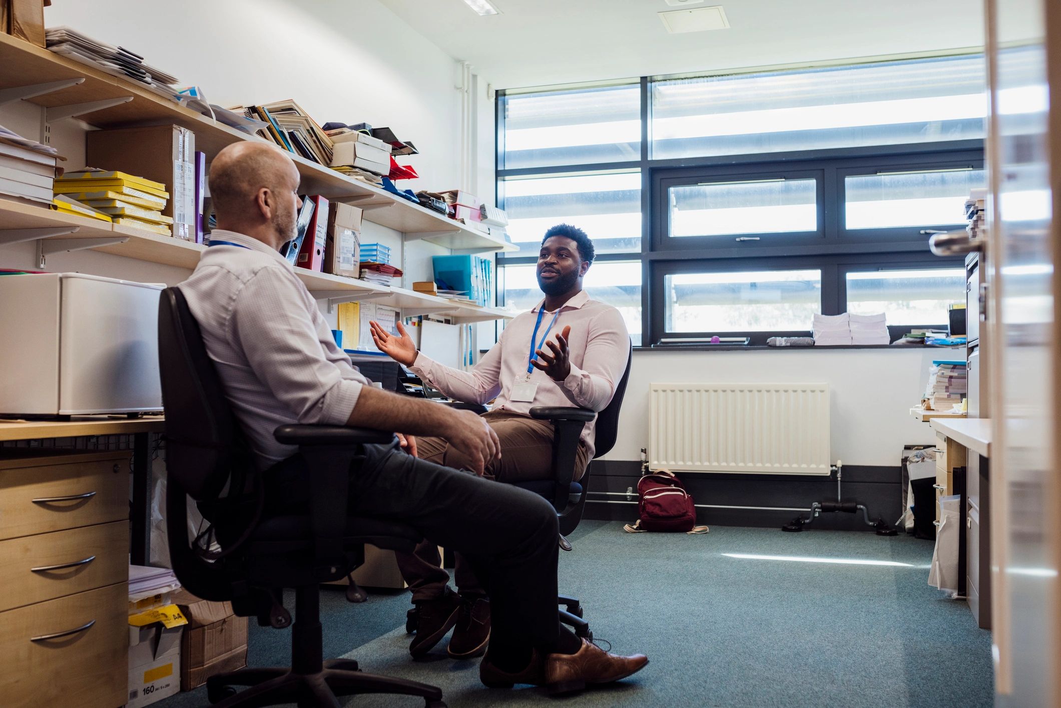Two professionals in focused strategy discussion